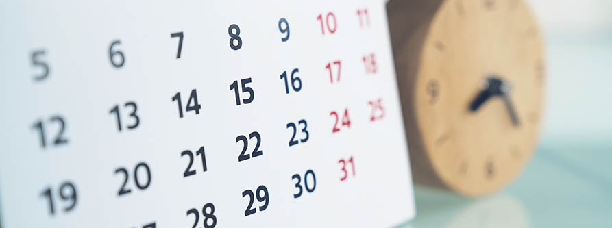 close up of calendar and clock on the table, planning for business meeting or travel planning concept